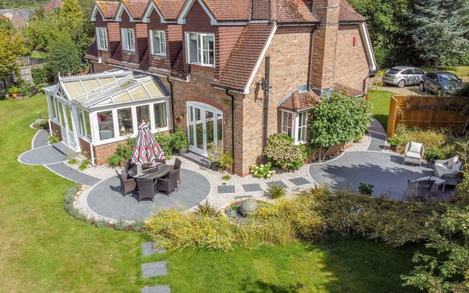 Circular themed garden with multiple defined seating areas and curved stone detailing
